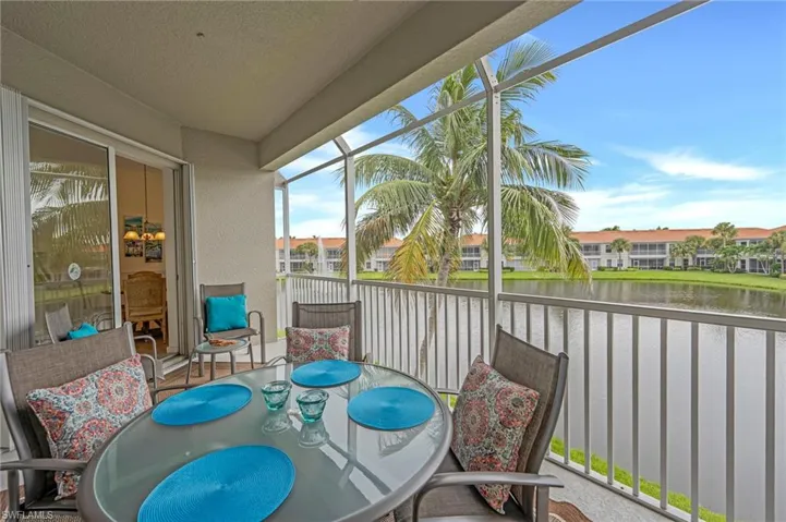 Balcony with a water view and outdoor dining space