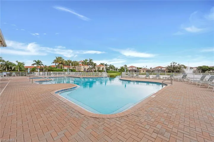 Community pool with a patio