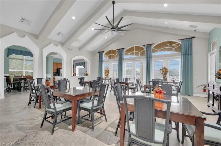 Dining room featuring high vaulted ceiling, beam ceiling, ceiling fan, recessed lighting, and french doors