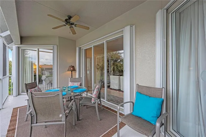 Sunroom with a ceiling fan and outdoor dining space