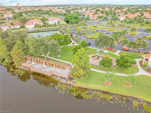 Aerial perspective of suburban area featuring a nearby body of water