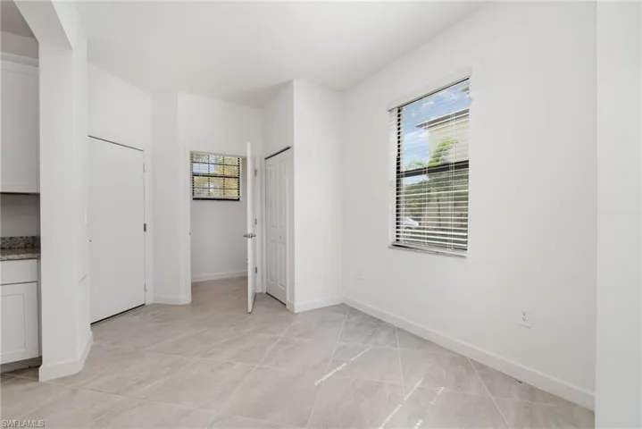 Unfurnished bedroom featuring light tile patterned floors and a closet