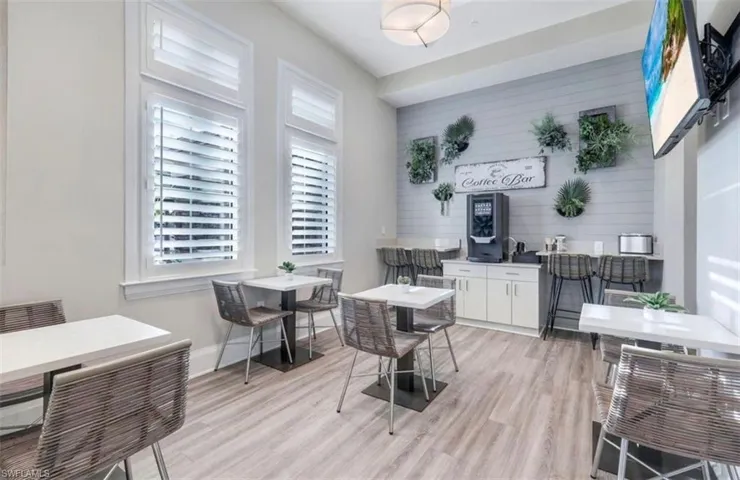 Dining area featuring light wood finished floors and wood walls