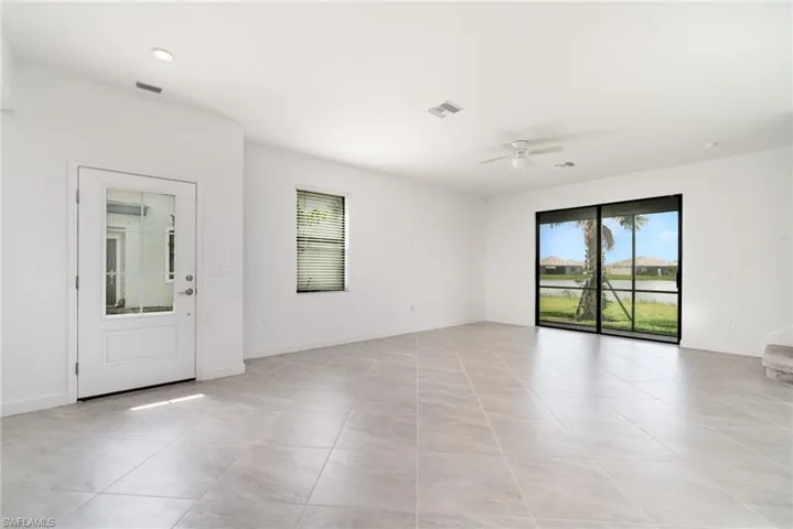 Spare room featuring light tile patterned floors and ceiling fan