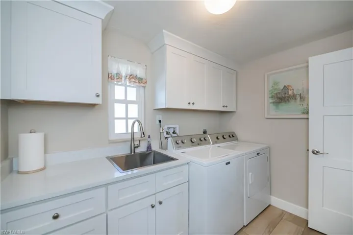 Laundry room with cabinets, washer and dryer