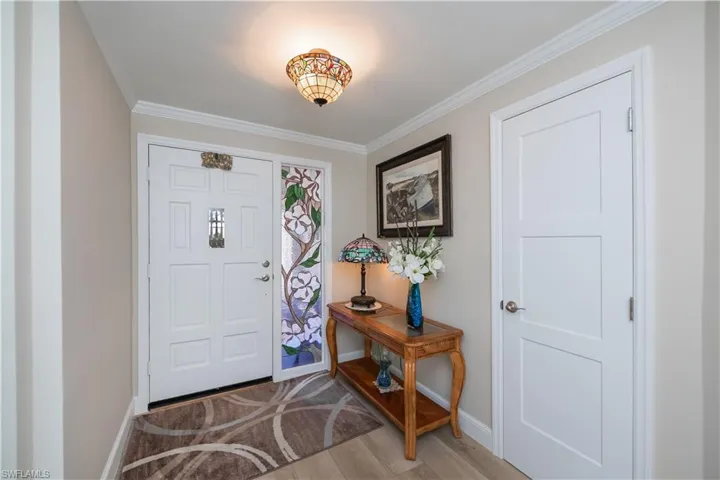 Foyer featuring crown molding and LVP flooring