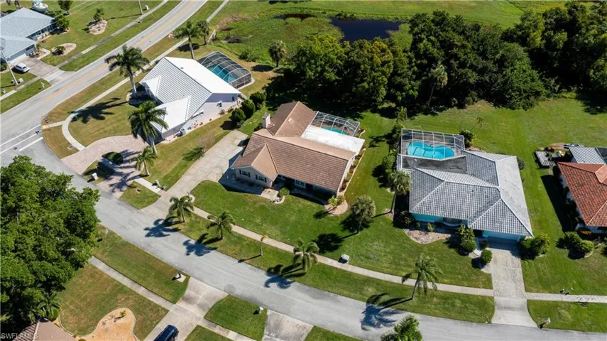 Aerial view of property and surrounding area featuring a pool area