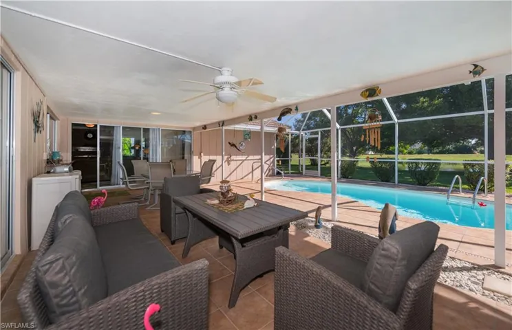 Swimming pool, lanai, ceiling fan, and outdoor dining area