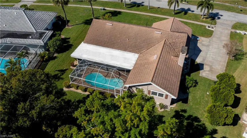 Aerial view of property and surrounding area featuring a pool