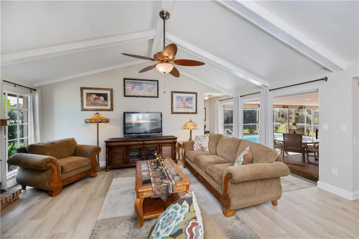 Living room with light wood-style floors and ceiling fan