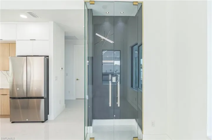 Empty room featuring a raised ceiling, recessed lighting, and ceiling fan