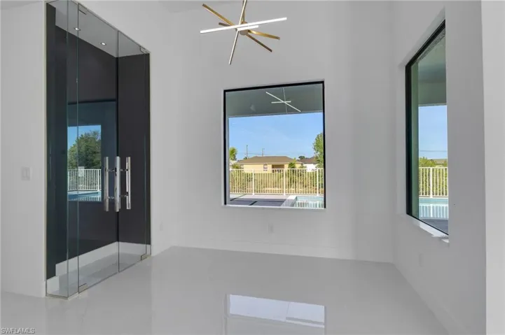Tiled empty room featuring baseboards and recessed lighting