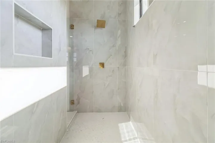 Unfurnished bedroom with a closet and light tile patterned flooring
