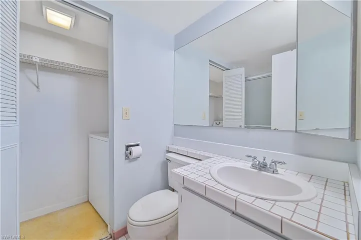 Bathroom featuring vanity and washer / dryer
