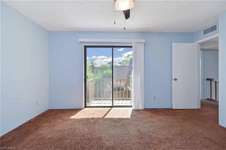 Unfurnished room with carpet floors, a textured ceiling, and ceiling fan