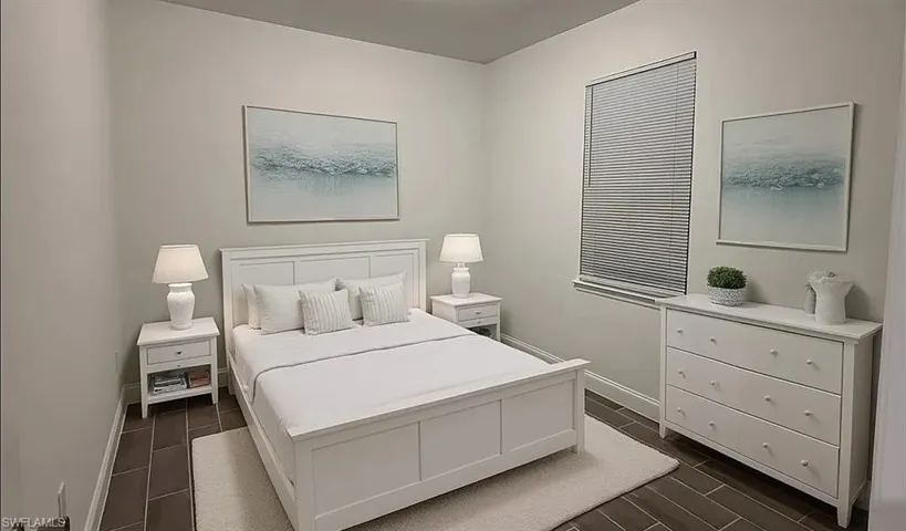 Bedroom featuring baseboards and wood finish floors
