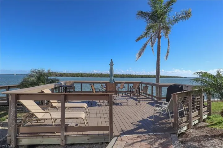Wooden terrace featuring a water view of Estero Bay