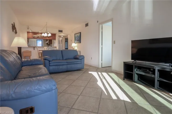 Living area featuring a chandelier and tile patterned floors