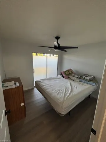 Bedroom featuring ceiling fan and dark wood-type flooring
