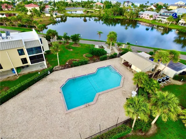 View of pool with a patio and a water view