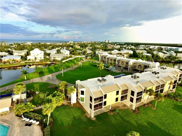 Birds eye view of property with a water view