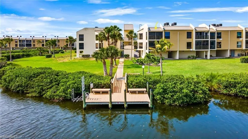 Pre-hurricane. Dock area featuring a yard and a water view