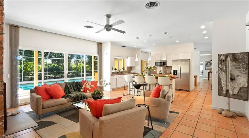 Living area with light tile patterned floors, ceiling fan, and recessed lighting