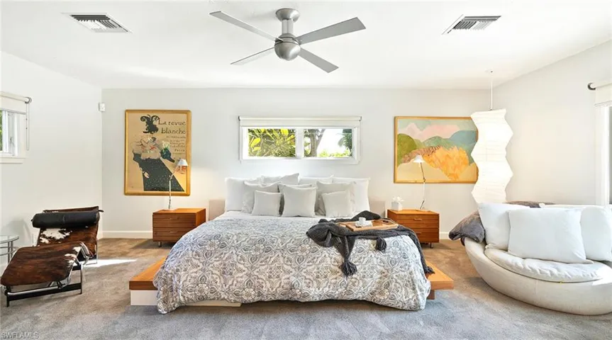 Carpeted bedroom with ceiling fan