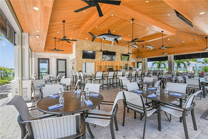 Dining area with beamed ceiling, ceiling fan, wood ceiling, and high vaulted ceiling