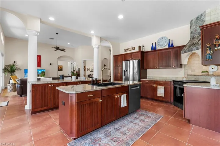 Laundry area with cabinet space, separate washer and dryer, and dark tile patterned flooring