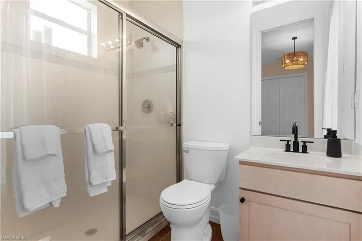 Bedroom featuring dark tile patterned flooring and connected bathroom