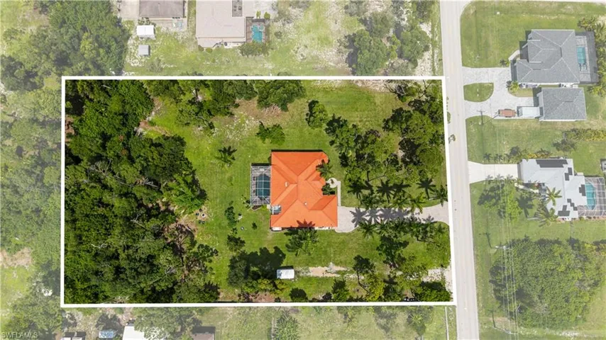 Mediterranean / spanish-style home with a tiled roof, decorative driveway, stucco siding, an attached garage, and a front yard
