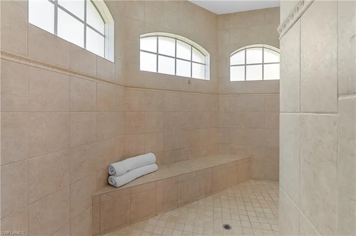 Full bathroom with tile patterned flooring, vanity, a garden tub, and recessed lighting
