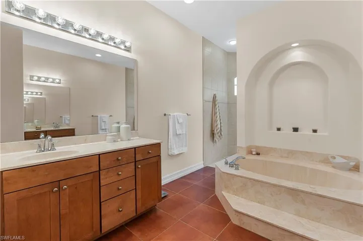 Bathroom with baseboards and tile patterned flooring