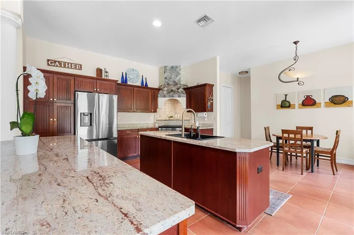 Dining space with french doors, light tile patterned floors, decorative columns, and recessed lighting