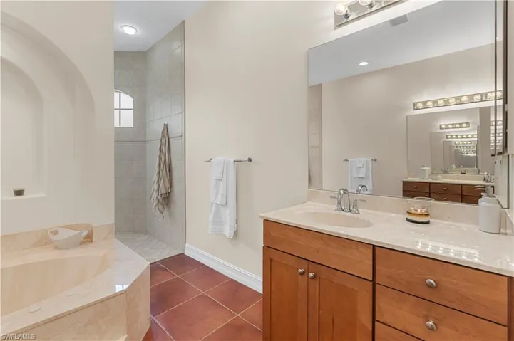 Bathroom featuring a bath and tile patterned flooring