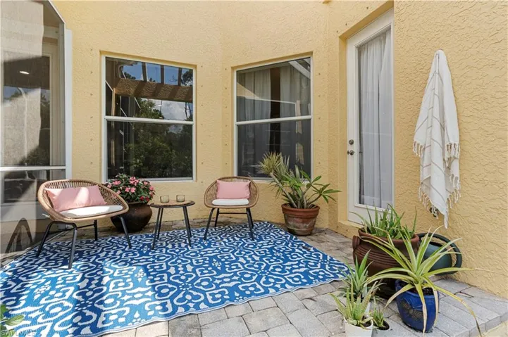 Full bath featuring tile patterned floors, a jetted tub, and two vanities