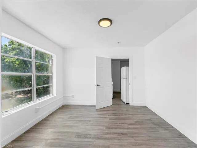 Empty room with light wood-style floors and baseboards