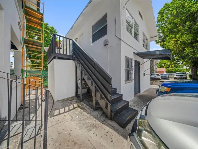 View of home's exterior with stucco siding and stairway