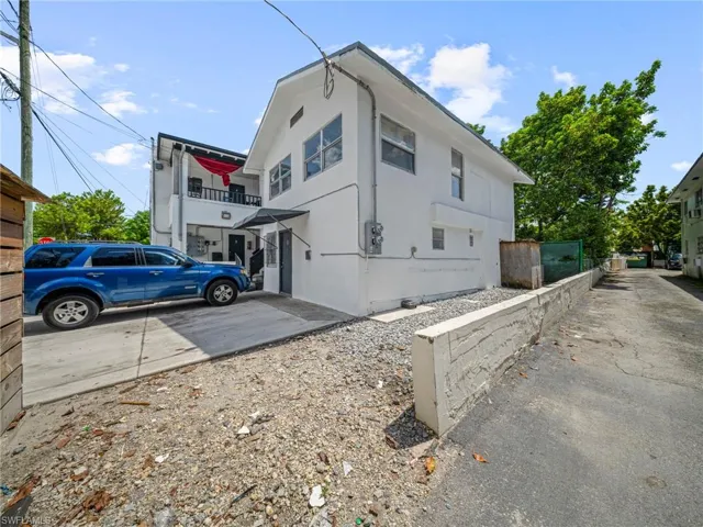 View of side of property with a balcony
