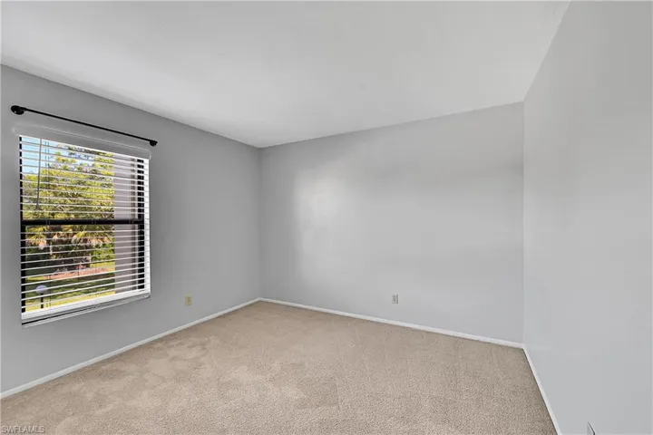 Empty room with baseboards and light carpet