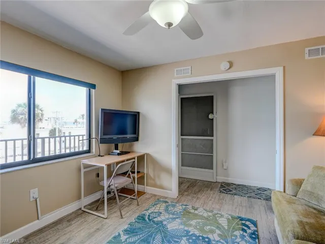 Home office with ceiling fan and light hardwood / wood-style flooring