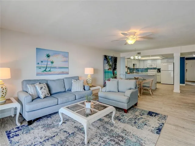 Living room featuring ceiling fan and light wood-type flooring
