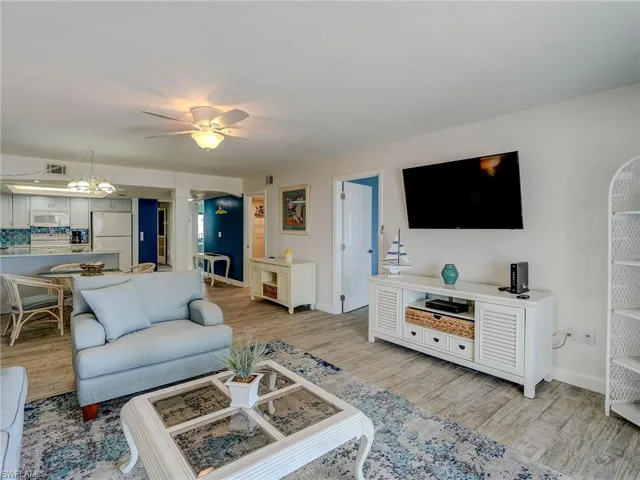 Living room with ceiling fan and light hardwood / wood-style flooring
