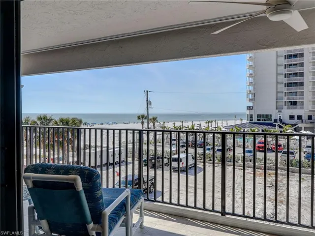 Balcony with a water view and ceiling fan