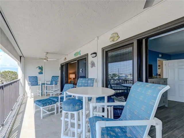 View of patio with a balcony and ceiling fan