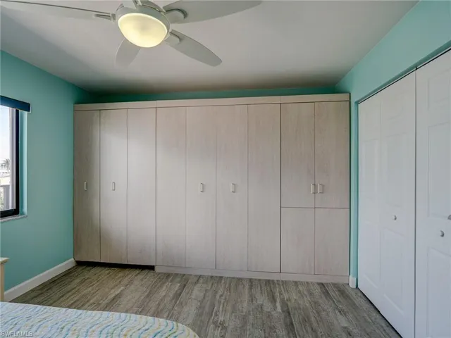 Unfurnished bedroom featuring light hardwood / wood-style floors, a closet, and ceiling fan