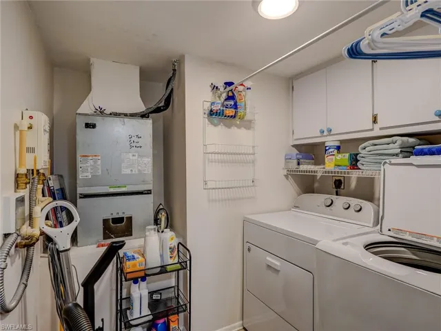 Clothes washing area with separate washer and dryer and cabinets