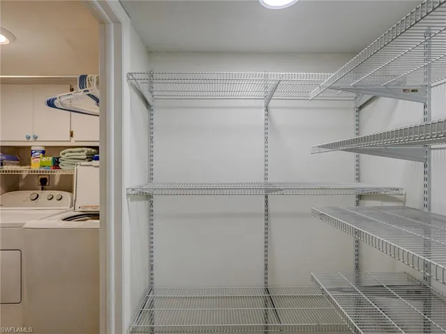 Spacious closet featuring washing machine and clothes dryer