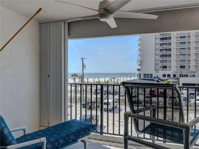 Balcony with a water view and ceiling fan
